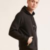 Soft black hoodie with gold zipper pocket, ribbed cuffs, and kangaroo front pocket