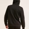 Durable black hoodie with gold zipper pocket, ribbed details, and thick cotton fabric