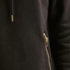 Soft black hoodie with gold zipper pocket, ribbed cuffs, and durable stitching