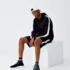 Black and white hoodie with side stripes, crafted from soft cotton blend, featuring ribbed cuffs and front kangaroo pocket