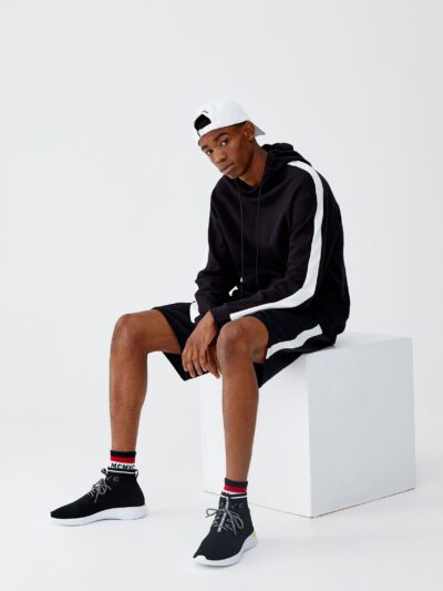 Black and white hoodie with side stripes, crafted from soft cotton blend, featuring ribbed cuffs and front kangaroo pocket