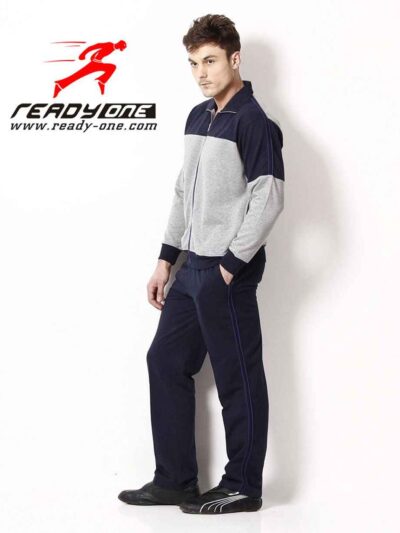 Close-up of a bespoke tracksuit. Fine stitching on navy fabric, showcasing a subtle sheen and comfortable, relaxed fit. Ideal
