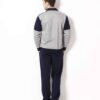 Close-up of a bespoke tracksuit. Fine stitching on navy fabric, showcasing a subtle sheen and comfortable, relaxed fit. Ideal