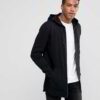 Black zip-up hoodie with custom logo option. Soft, textured fabric. Longline fit. Quality stitching detail evident. Perfect f