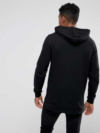 Black zip-up hoodie with custom logo option. Soft, textured fabric. Longline fit. Quality stitching detail evident. Perfect f