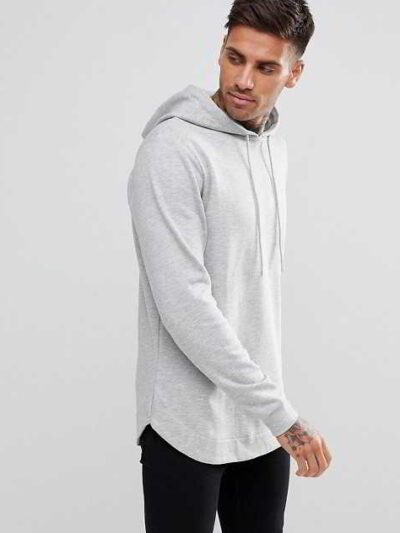 Slate grey, longline hoodie with a distinctive curved hem, exhibiting a soft, fine-textured fabric and well-crafted stitching