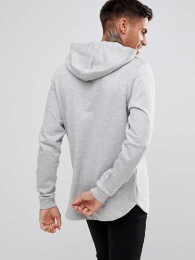 Slate grey, longline hoodie with a distinctive curved hem, exhibiting a soft, fine-textured fabric and well-crafted stitching