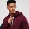 Stylish maroon zip hoodie showcasing unique panel design, soft fabric texture, and intricate stitching details
