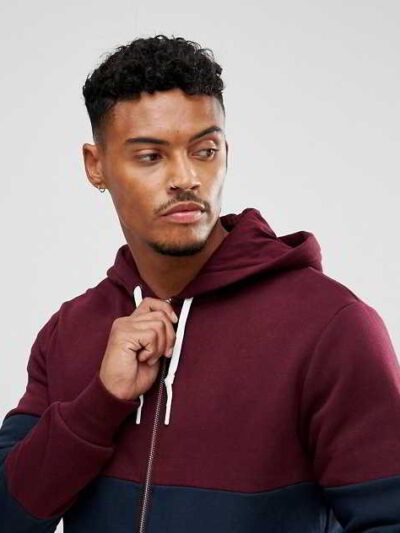 Stylish maroon zip hoodie showcasing unique panel design, soft fabric texture, and intricate stitching details
