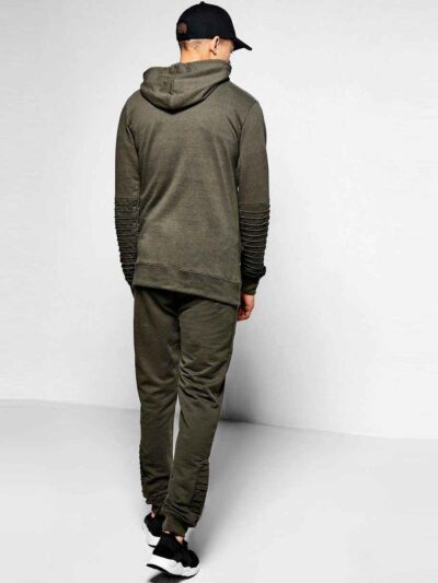 Ribbed biker tracksuit in soft cotton. Close-up shows textured fabric, reinforced stitching, and customizable panels. Premium