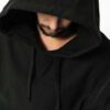 Sophisticated all black hoodie, exhibiting high-quality fabric texture and meticulous stitching detail.