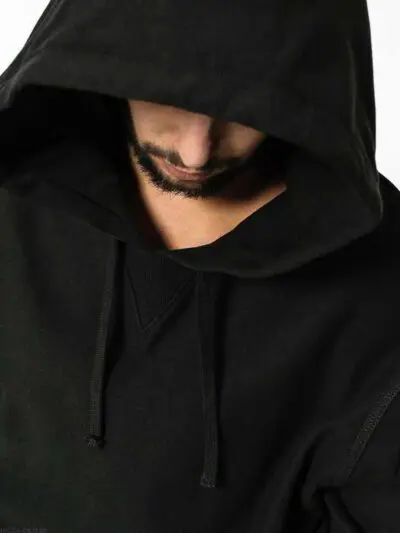 Sophisticated all black hoodie, exhibiting high-quality fabric texture and meticulous stitching detail.