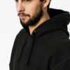 Premium all-black Hoodie displaying meticulous stitching, soft fabric texture and adjustable drawstring hood.