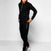 Biker-style tracksuit. Premium knit, visible stitching. Luxury sportswear: dark heather grey jacket, black bottoms. Sporty, c
