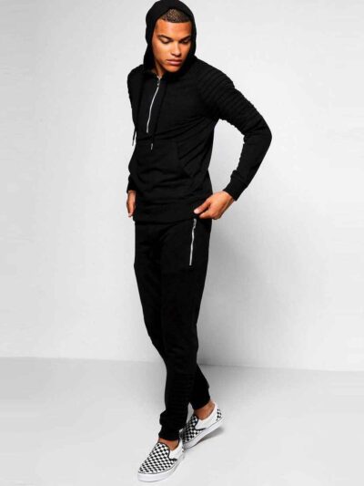 Biker-style tracksuit. Premium knit, visible stitching. Luxury sportswear: dark heather grey jacket, black bottoms. Sporty, c
