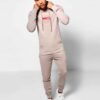 Skinny tracksuit set showing fine stitching. Close-up reveals a soft, textured knit fabric in a subtle heather gray with slim