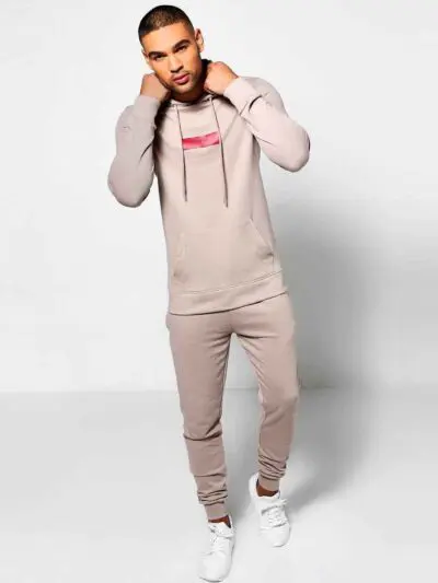 Skinny tracksuit set showing fine stitching. Close-up reveals a soft, textured knit fabric in a subtle heather gray with slim