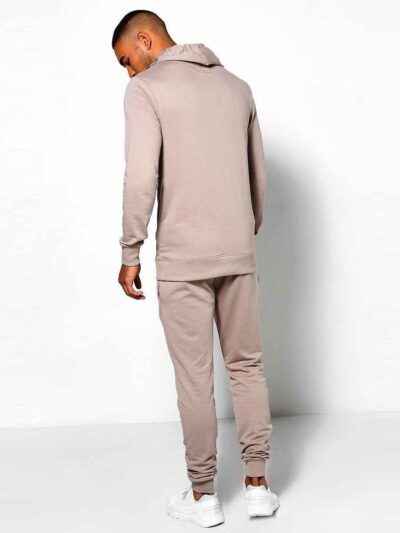 Skinny tracksuit set showing fine stitching. Close-up reveals a soft, textured knit fabric in a subtle heather gray with slim