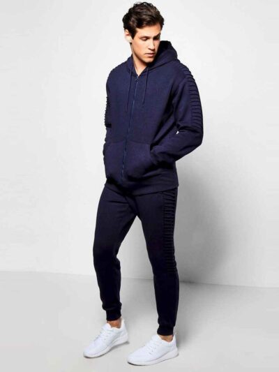 Ribbed knit tracksuit in charcoal gray. Streetwear style, paneled design, athletic fit. Notice the distinct ribbing texture a