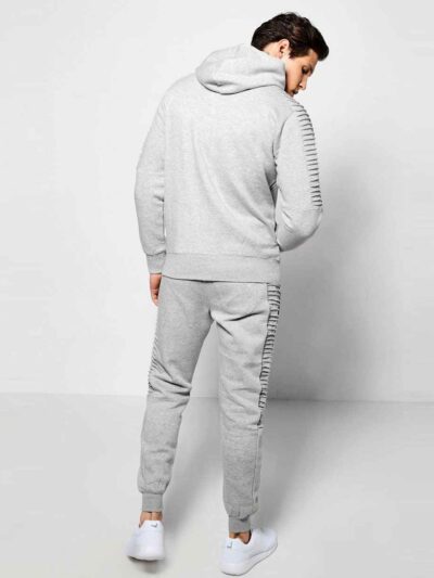 Ribbed knit tracksuit in charcoal gray. Streetwear style, paneled design, athletic fit. Notice the distinct ribbing texture a