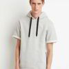 Elevated streetwear hoodie in a short sleeve design features contrasting stitches and soft-textured fabric