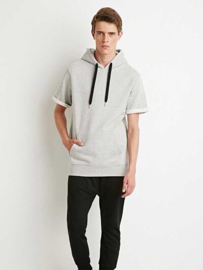 Close-up of short-sleeved streetwear hoodie in vivid colors, revealing detailed stitching, high-quality fabric texture with a