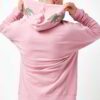 Light pink oversized hoodie with drop shoulders, showcasing a soft, plush fabric texture, meticulous stitching, and a versati