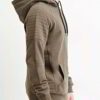 Close-up of a textured charcoal grey biker hoodie. Heavy stitching, oversized hood, and comfortable pullover style visible. Q