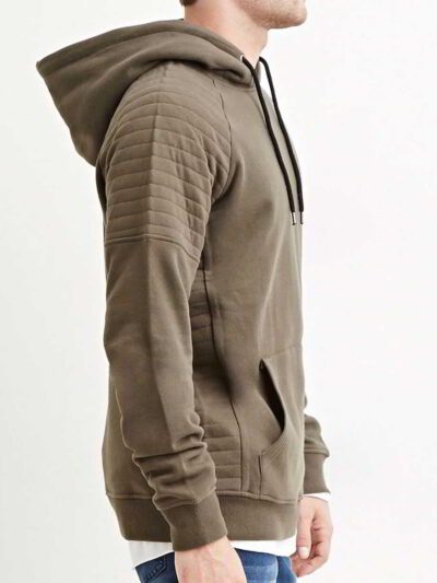 Close-up of a textured charcoal grey biker hoodie. Heavy stitching, oversized hood, and comfortable pullover style visible. Q