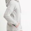 Close-up of a textured charcoal grey biker hoodie. Heavy stitching, oversized hood, and comfortable pullover style visible. Q