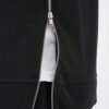 Sleeveless black hoodie. Close-up shows textured fabric, durable stitching. Custom cut & sew design. Athletic, modern menswea