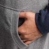 Oversized heather gray streetwear hoodie with kangaroo pocket and ribbed hem, made from soft cotton blend