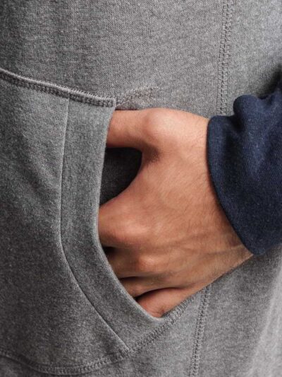 Oversized heather gray streetwear hoodie with kangaroo pocket and ribbed hem, made from soft cotton blend