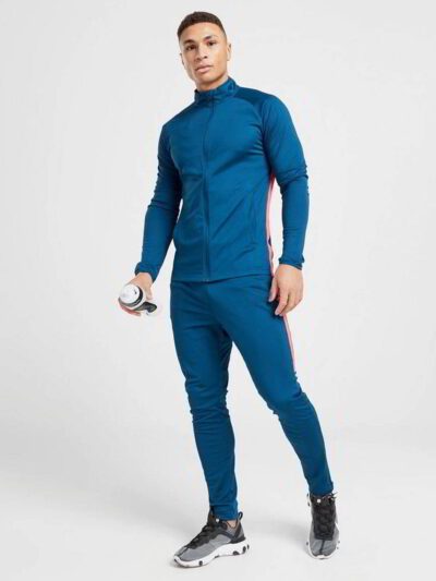 Running tracksuit with raglan sleeves, showing polyester texture. Partial zipper and visible stitching detail. Athletic wear.