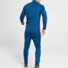 Running tracksuit with raglan sleeves, showing polyester texture. Partial zipper and visible stitching detail. Athletic wear.
