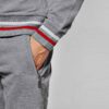 Sporty short tracksuit in bulk production. Ribbed knit trim, contrasting side stripes, close-up showing smooth, durable fabri