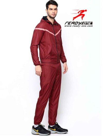 Crimson & black sports tracksuit; performance fabric, subtle stitching, comfortable fit. Ideal for custom athletic apparel pr