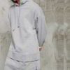 Premium longline hoodie in black cotton with front kangaroo pocket and ribbed cuffs