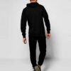 Slim athletic tracksuit. Close-up shows fine stitching, smooth fabric texture; hints of deep blues and charcoal grey. Streaml