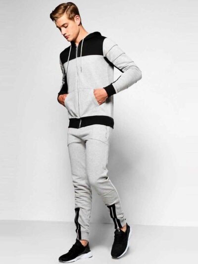Skinny fit jogging tracksuit: panel design, custom cut and sew. Noticeable fabric texture, detailed stitching, athletic wear.