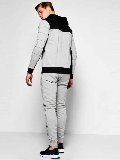Skinny fit jogging tracksuit: panel design, custom cut and sew. Noticeable fabric texture, detailed stitching, athletic wear.