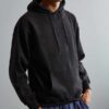 Soft black hoodie with front pocket and ribbed cuffs, crafted from sustainable materials