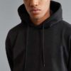Premium black hoodie with kangaroo pocket and ribbed cuffs in heavyweight cotton fabric