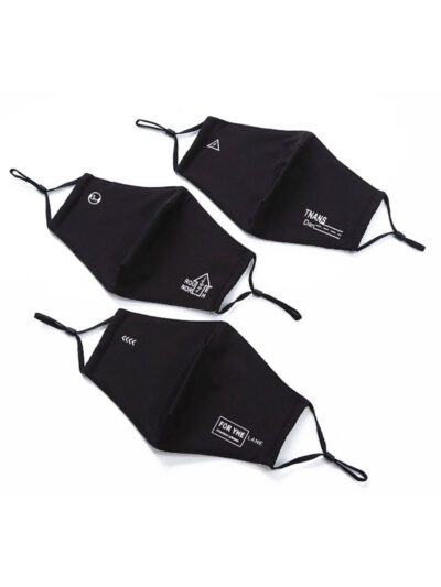 Close-up of a breathable black fabric mouth mask. Adjustable straps, fine stitching detail. Reusable dust protection. - View