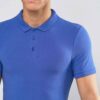 Close-up of a polo shirt, wrinkle-resistant fabric, fine stitching, subtle texture, workwear style in a light blue hue. Comfo