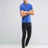 Close-up of a polo shirt, wrinkle-resistant fabric, fine stitching, subtle texture, workwear style in a light blue hue. Comfo