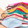 Vibrant assorted face masks. Soft, breathable fabric, meticulous stitching. Reusable cloth masks in blue, pink, and yellow hu