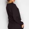 Black sweat suit with ripped knee detail, comfortable loungewear. Soft, textured fabric, visible stitching. Casual, stylish.