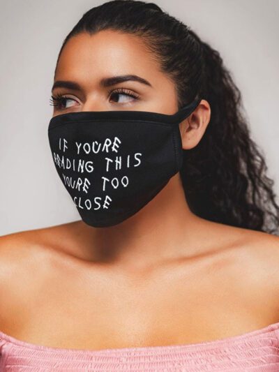Close-up: Black fabric face mask with custom print. Soft, textured material, clean stitching. Daily use, unisex design. - Vie