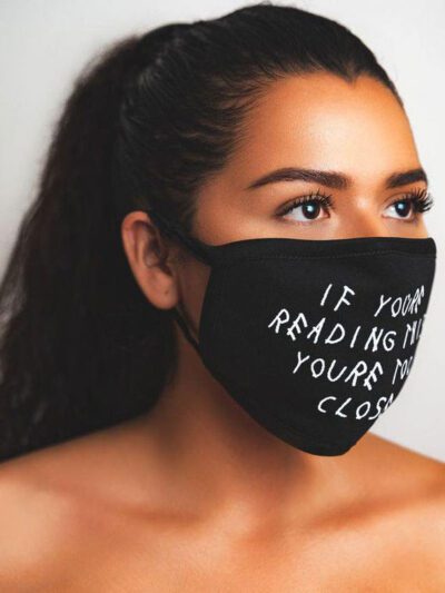 Close-up: Black fabric face mask with custom print. Soft, textured material, clean stitching. Daily use, unisex design. - Vie